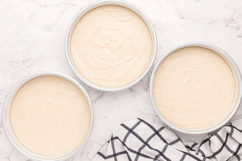 white wedding cake batter divided between 3 round cake pans.