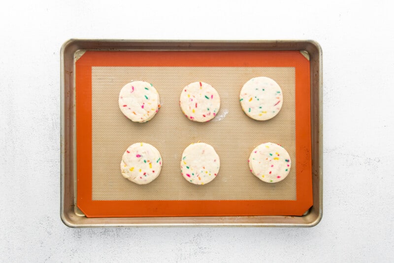 6 funfetti shortbread cookies on a baking sheet.