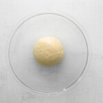 cinnamon roll muffin dough ball in a glass bowl.