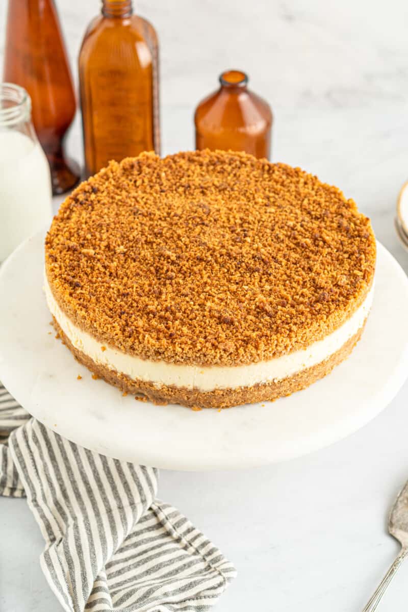 double crust cheesecake on a white cake stand.