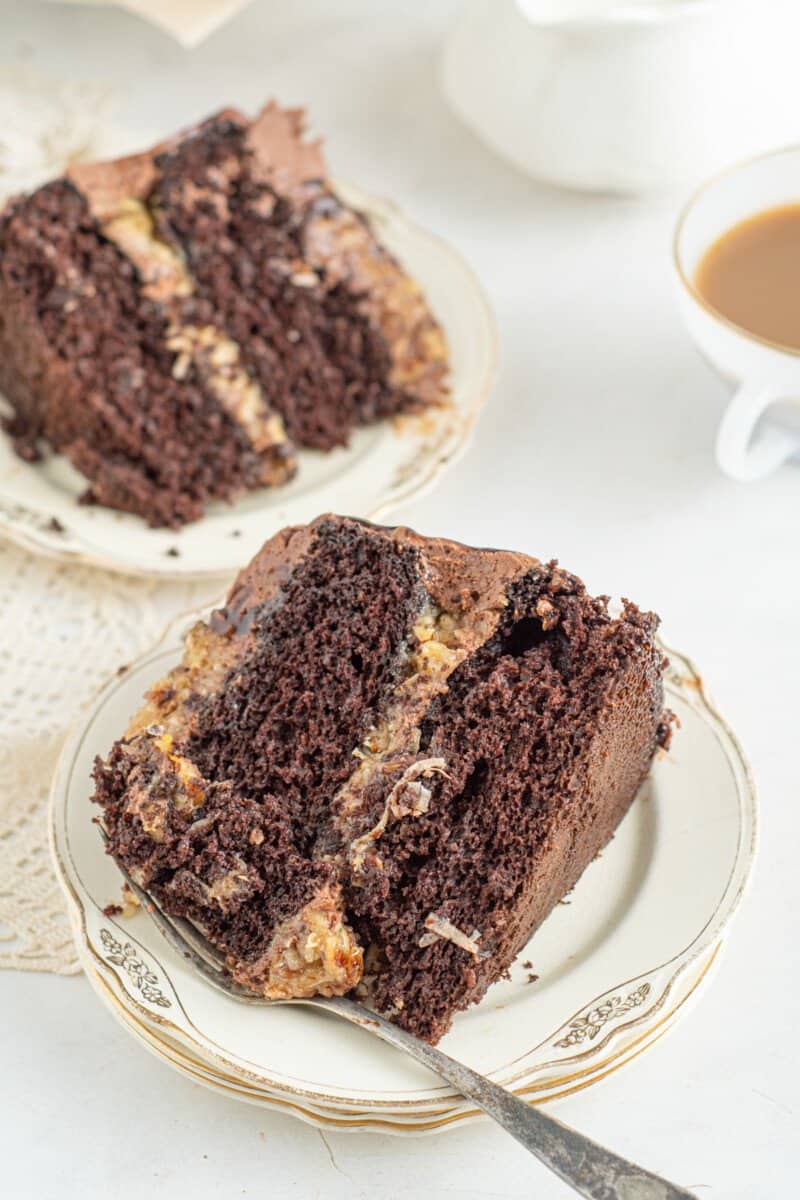 slices of german chocolate cake on white plates with forks.