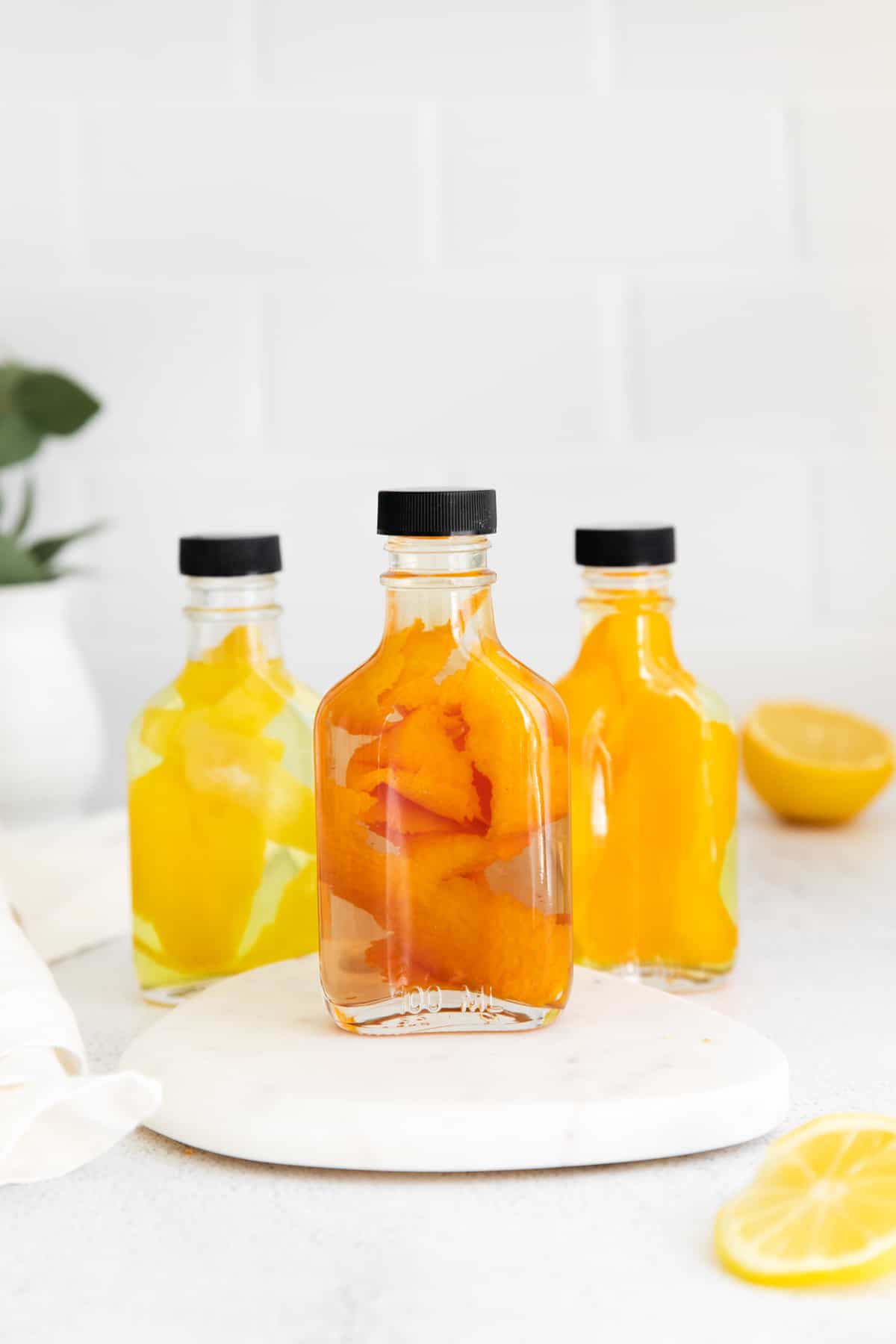 three bottles of homemade extracts (orange extract, lemon extract, and blood orange extract)
