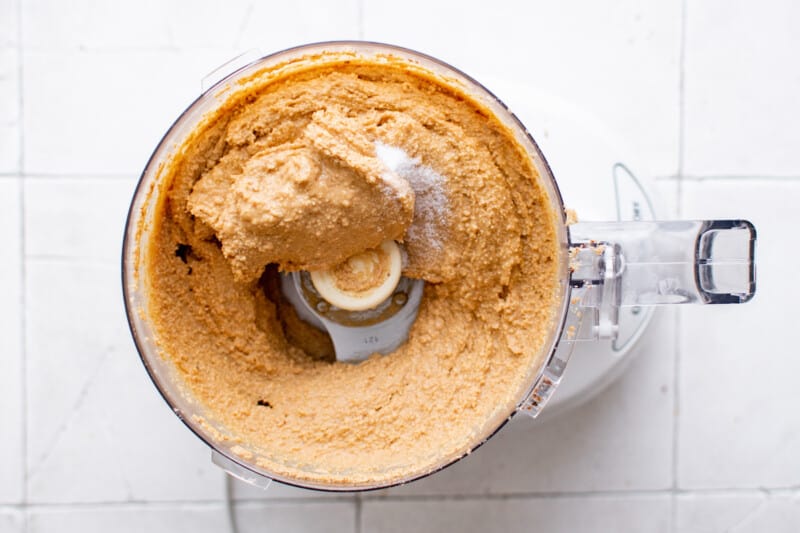 blended peanuts and salt combining in a food processor