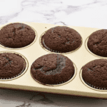baked chocolate cupcakes in a cupcake tin.