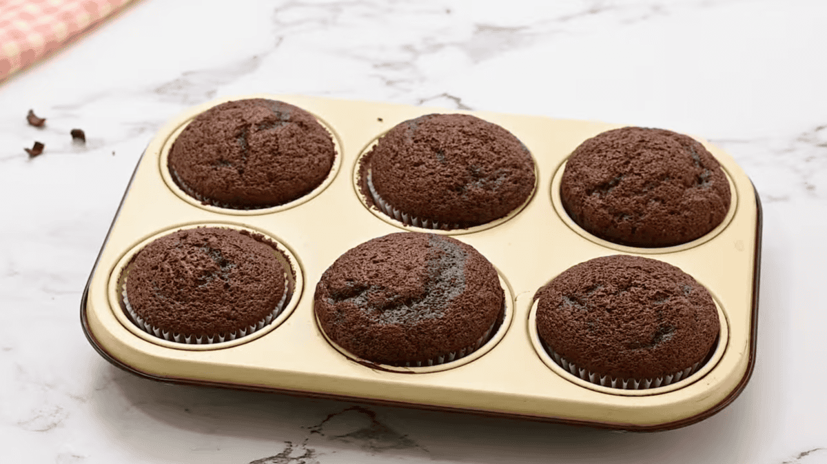 baked chocolate cupcakes in a cupcake tin.