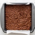 homemade crunch bar mix spread out in an 8x8 baking pan.
