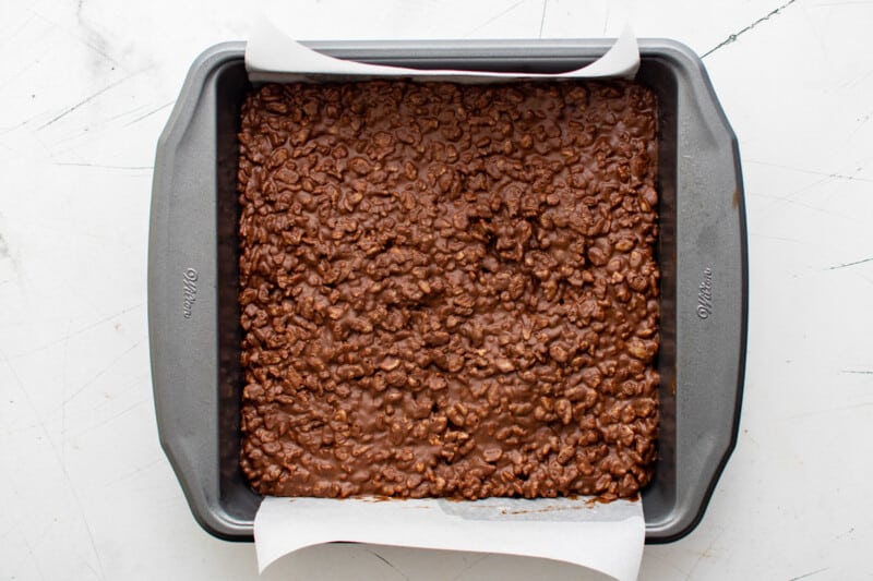 homemade crunch bar mix spread out in an 8x8 baking pan.
