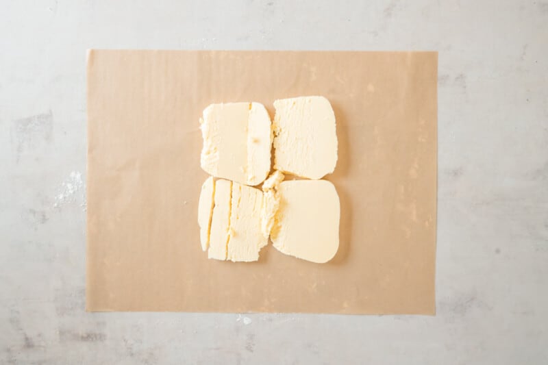 four pieces of butter on a piece of paper.