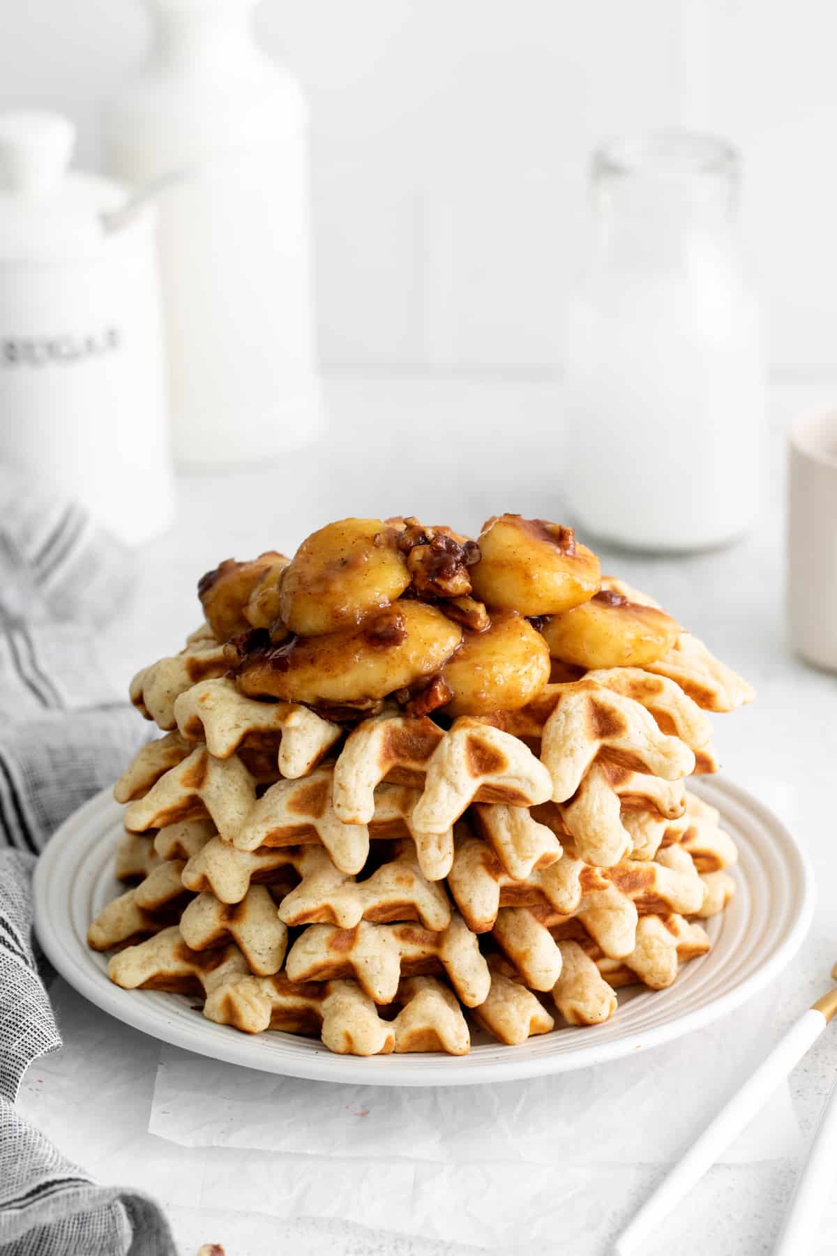 a stack of bananas foster waffles on a plate