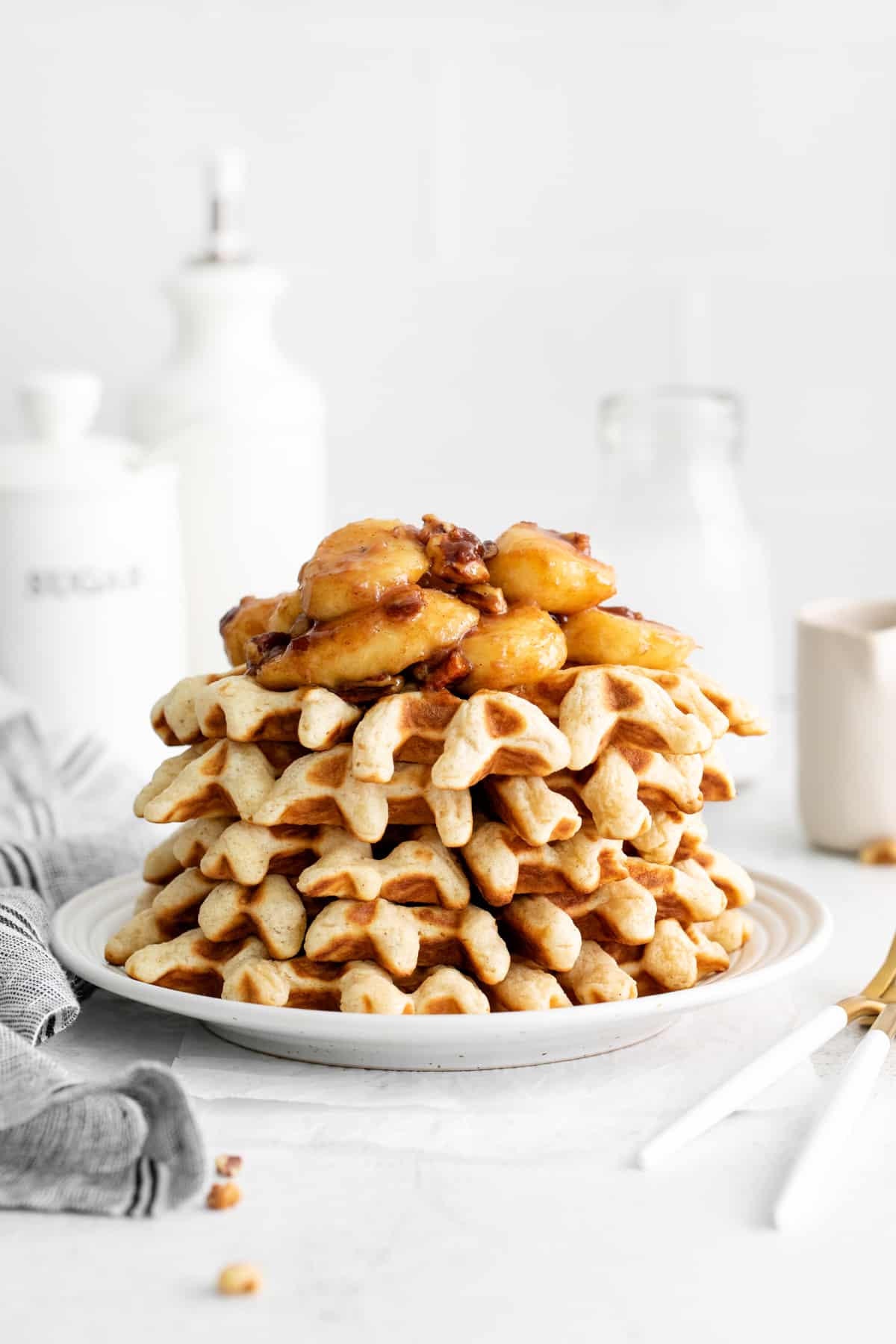 a stack of waffles with bananas foster topping