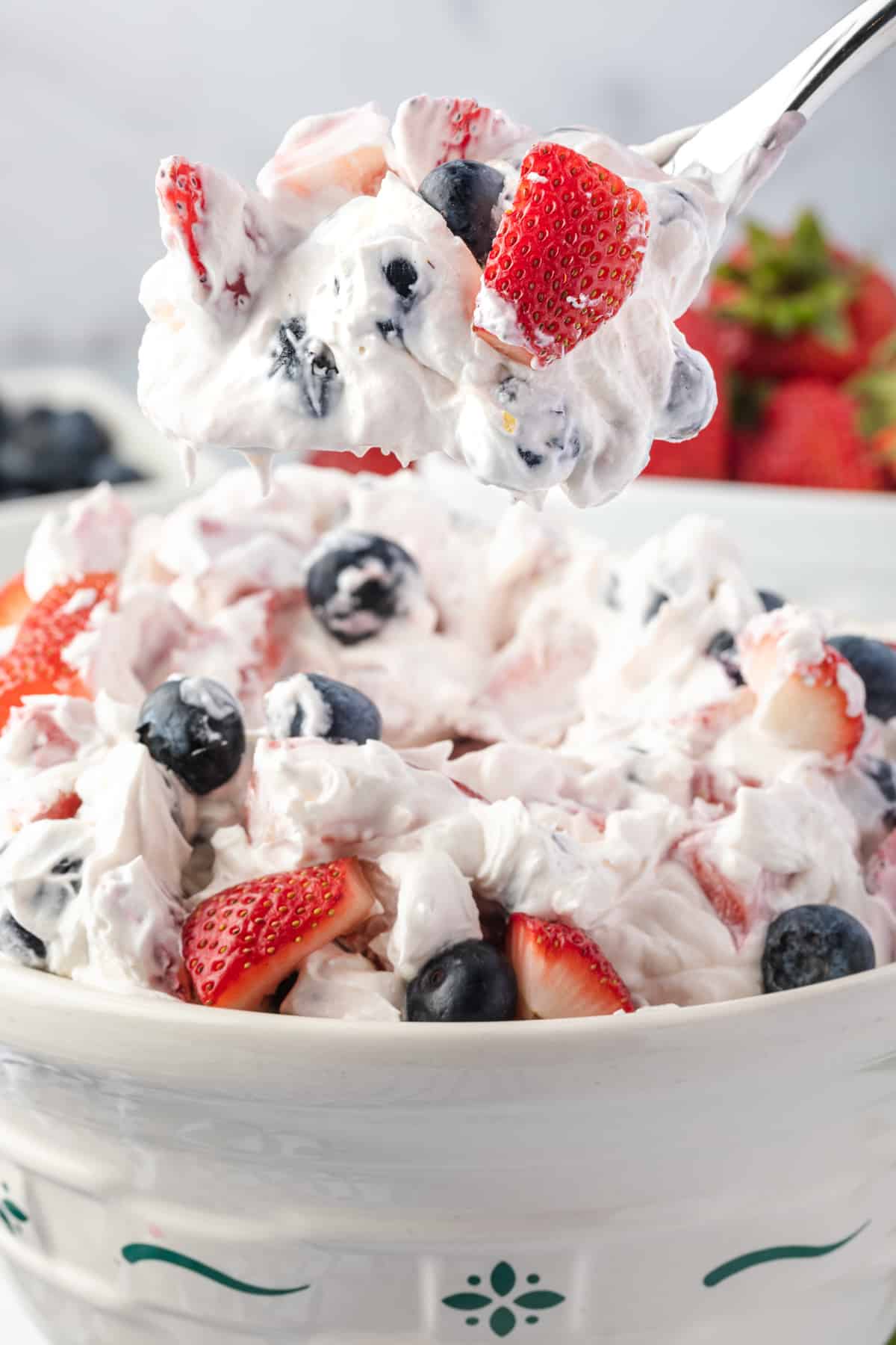 cheesecake fruit salad filled with blueberries and strawberries
