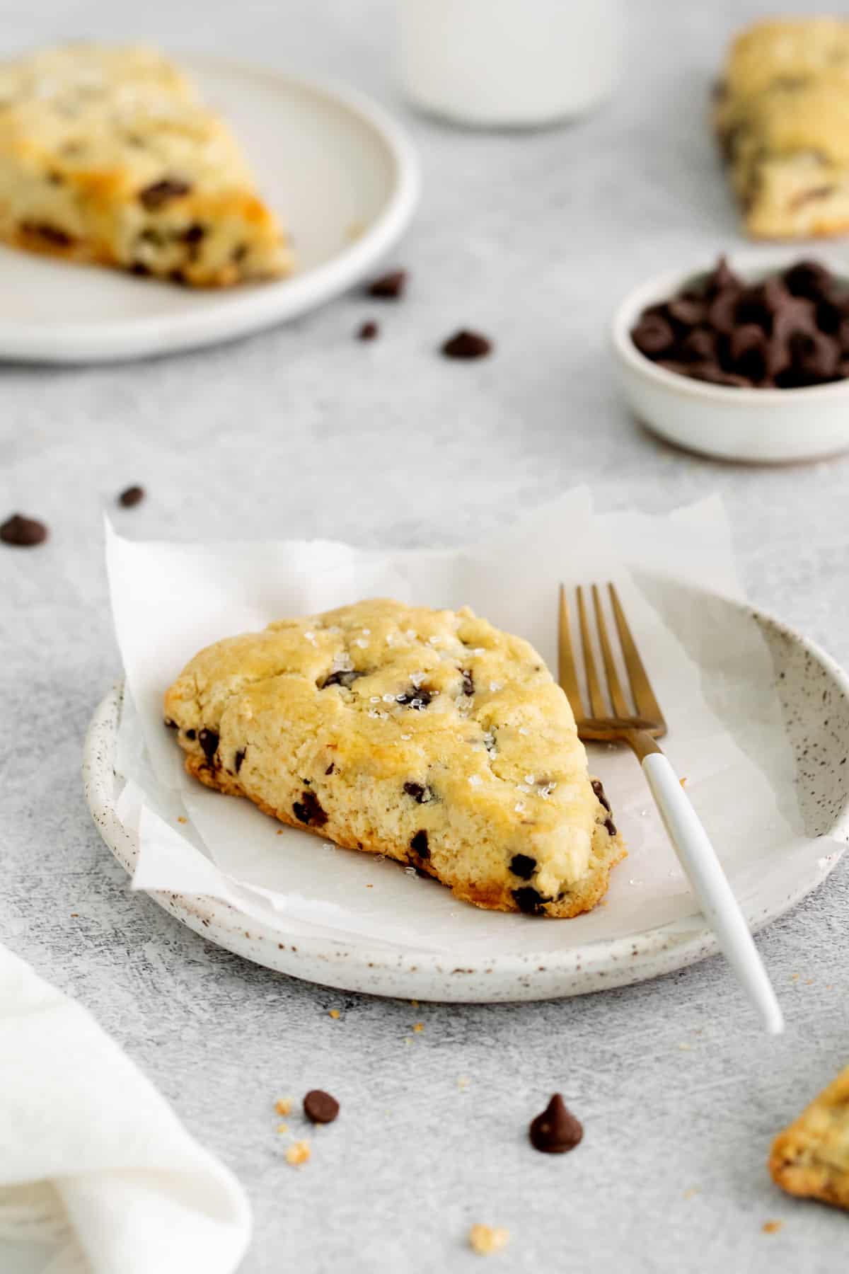 chocolate chip scone on a plate with a fork