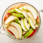 apple slices in a large glass measuring bowl