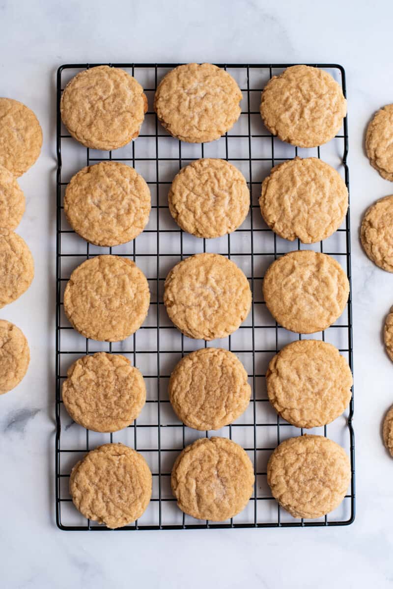 chewy brown sugar cookies lined up on a cooling rack