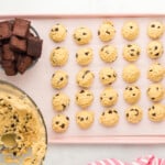 chocolate chip cooke dough balls and cubes of brownies arranged on a baking tray