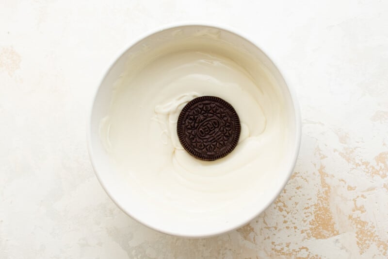 Oreo cookie in a bowl of white chocolate