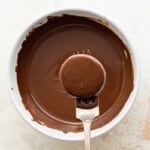 dipping an Oreo into melted chocolate using a fork