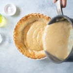 pouring butterscotch filling into a pie crust