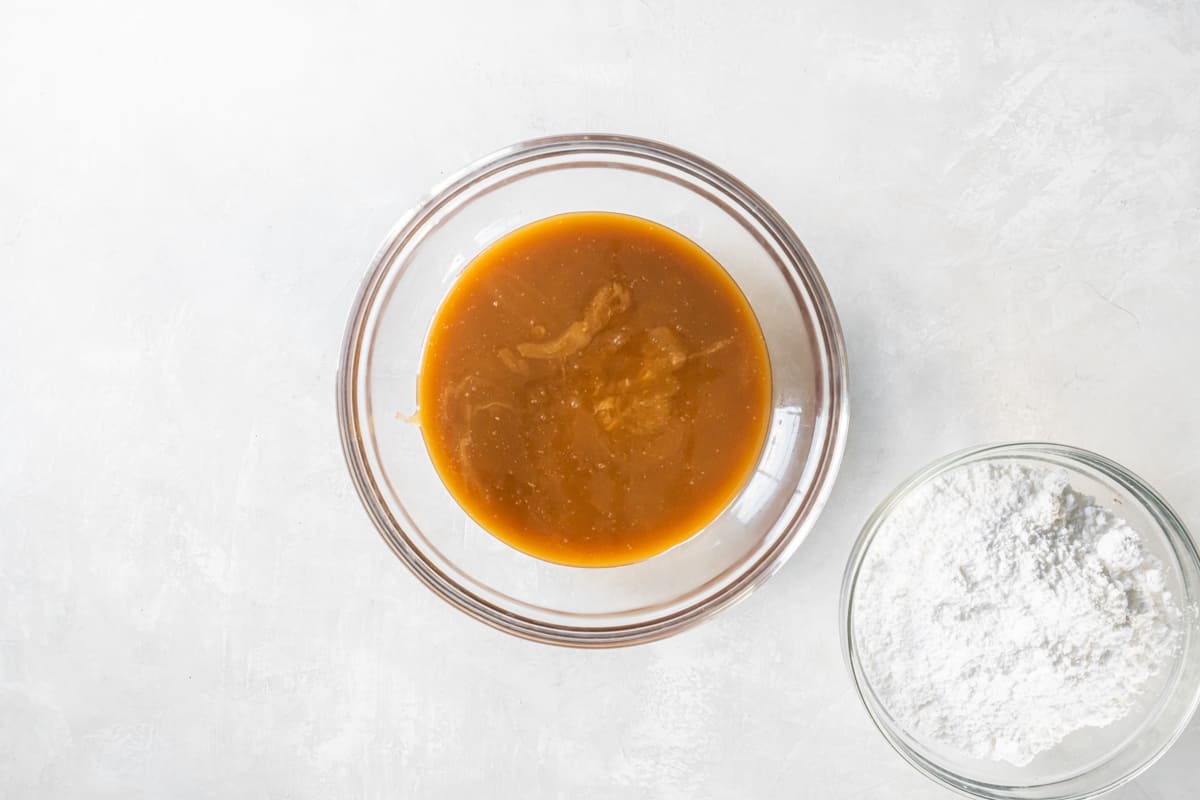 caramel frosting mixture in a mixing bowl