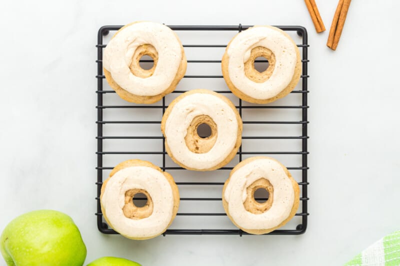 frosted donuts on a cooling rack