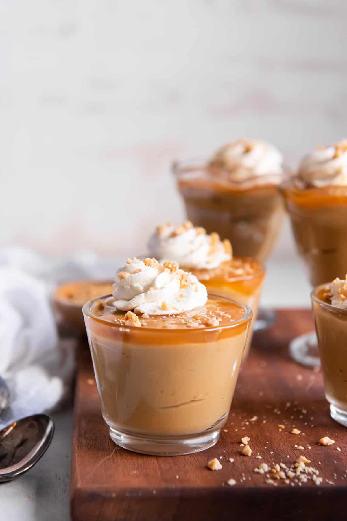 cups of butterscotch budino topped with whipped cream