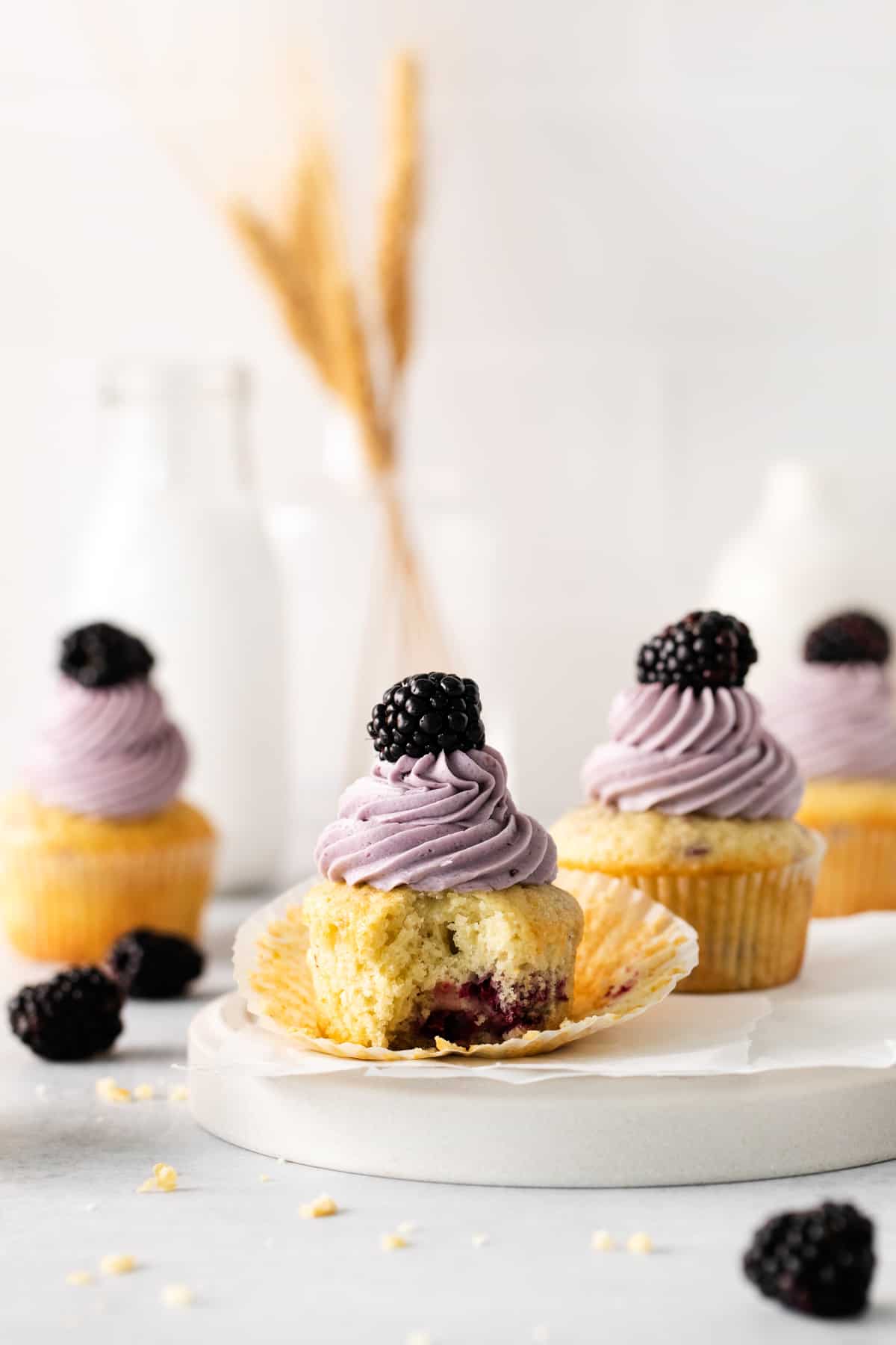 blackberry cupcakes, the one in front has a bite taken out of it