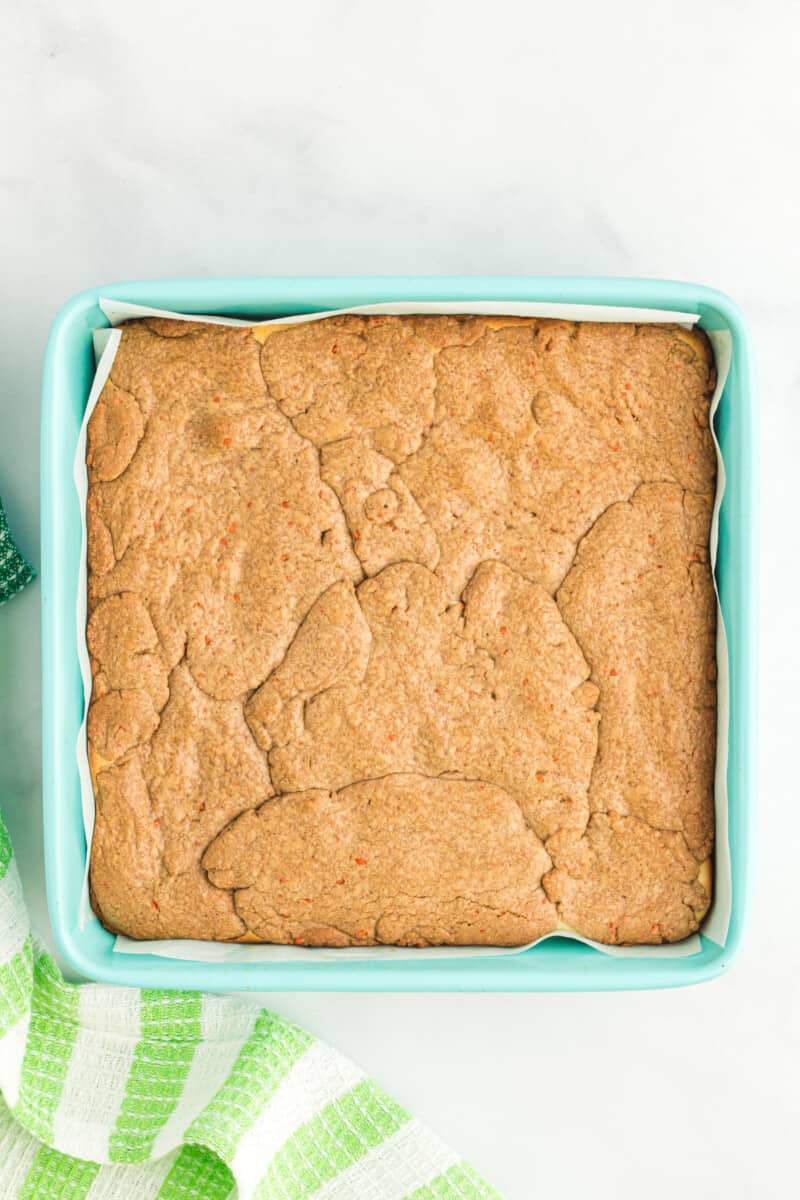 overhead view of carrot cake bars in a blue baking pan.