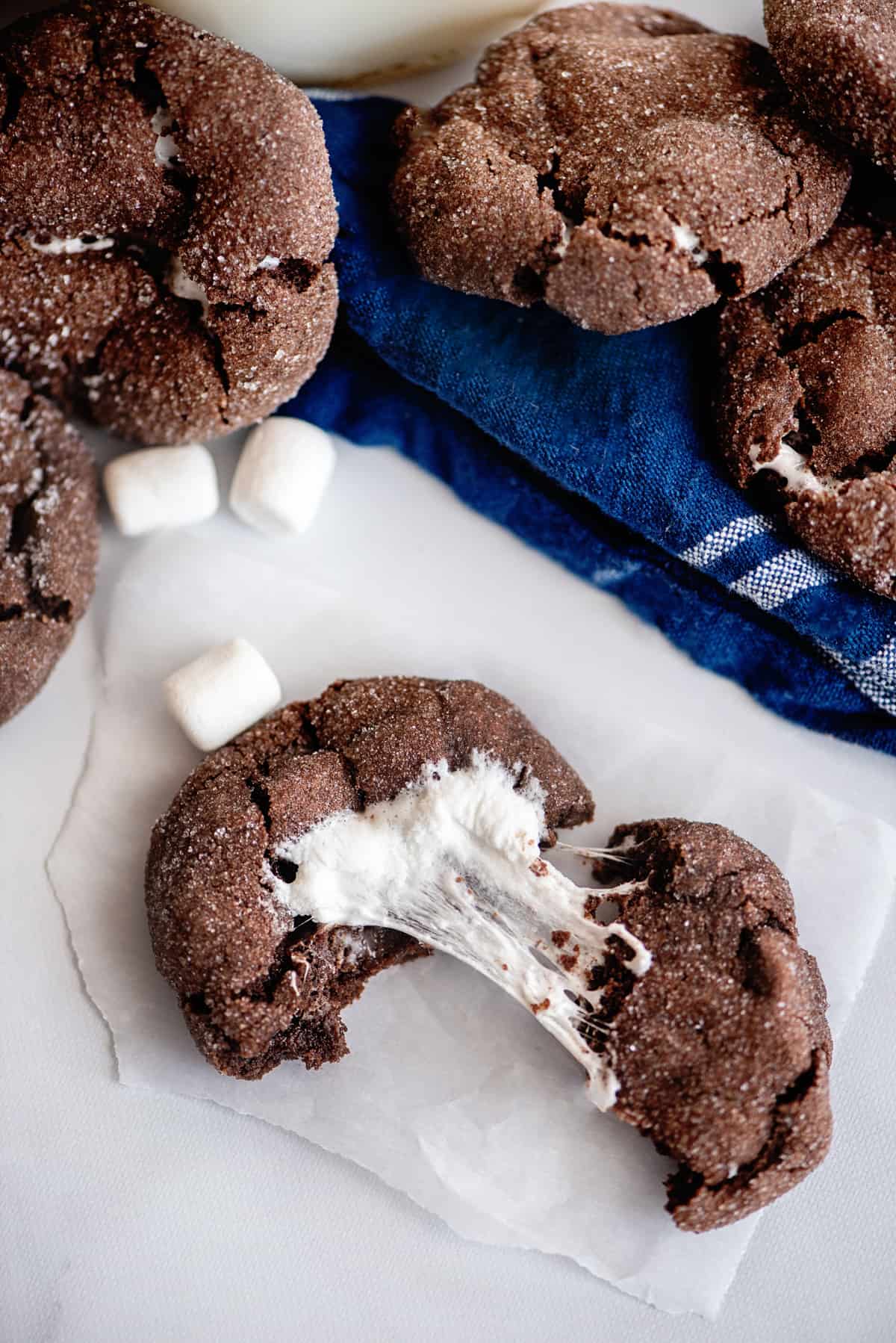chocolate cookie pulled apart to reveal the gooey marshmallow center