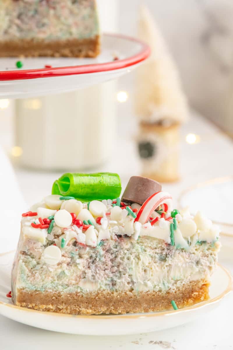 a slice of christmas cheesecake on a white plate.