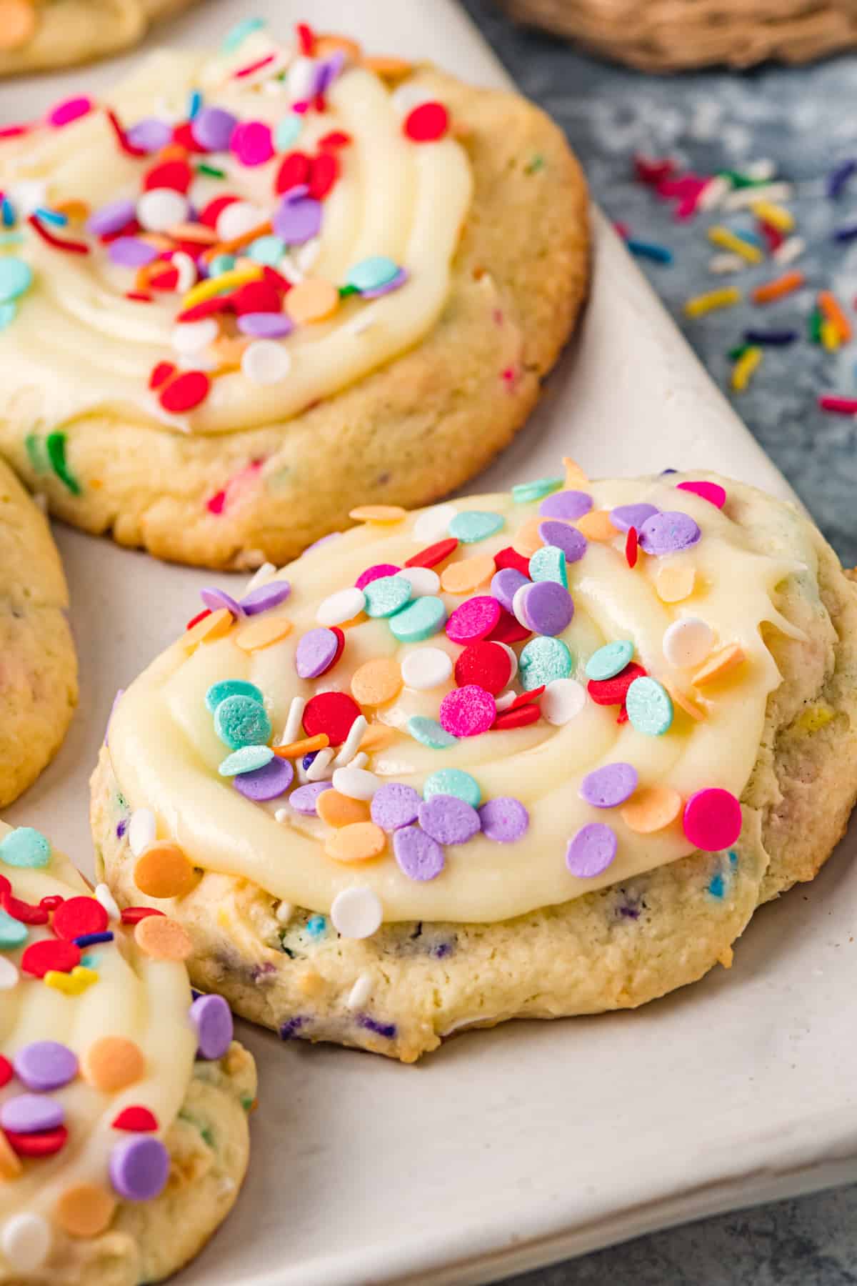 close up on copycat crumbl cookie topped with icing and sprinkles