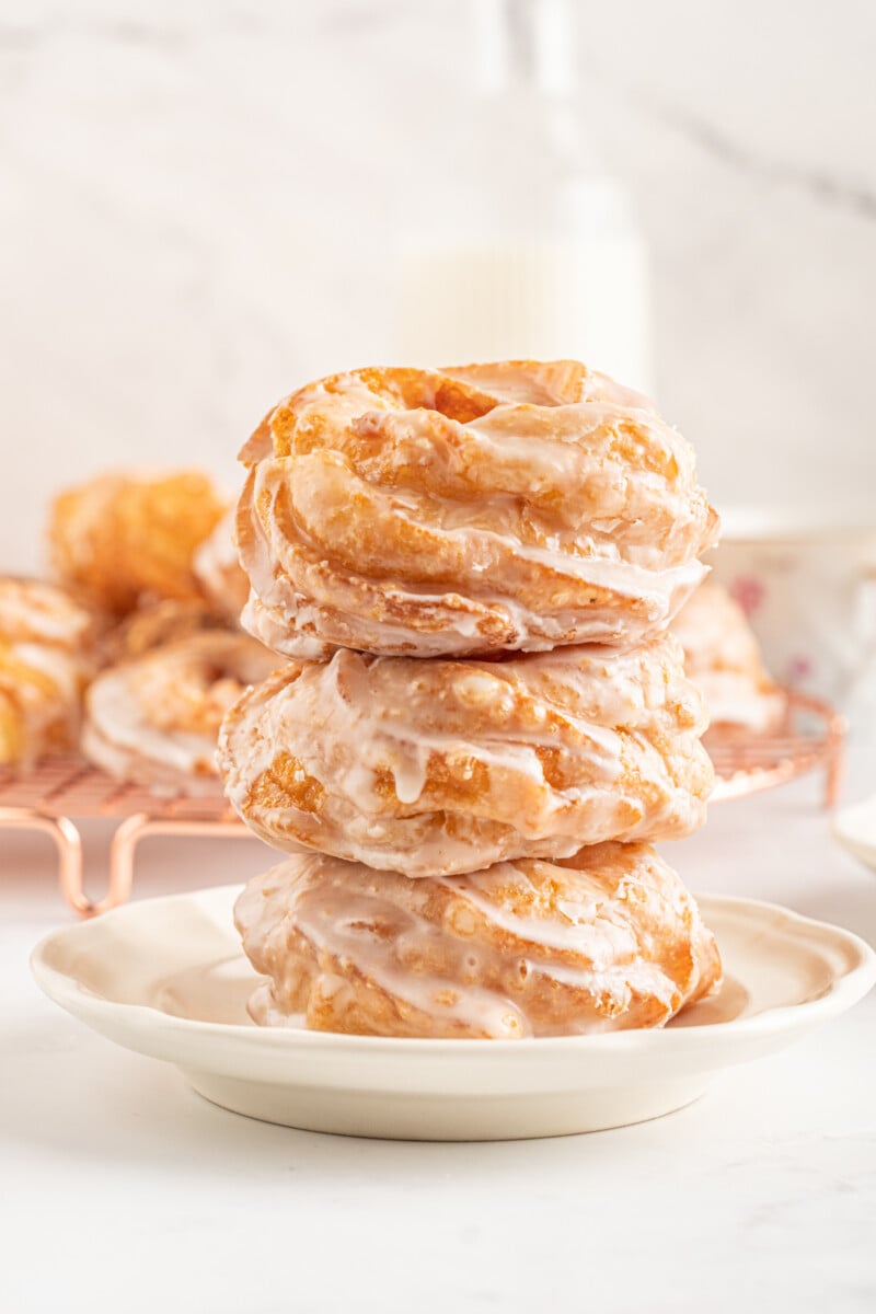 copycat French crullers stacked up on a plate