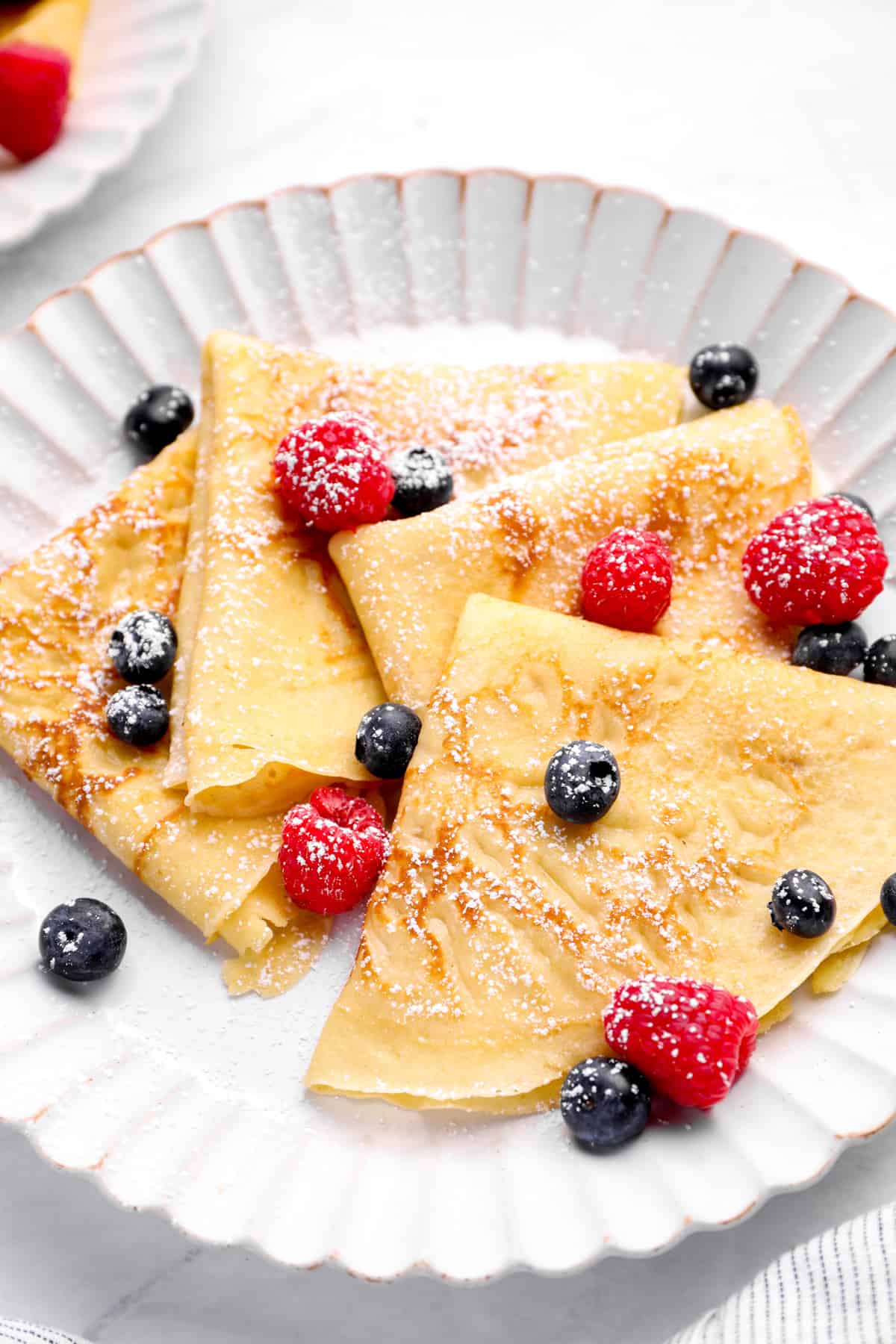 crepes plated with berries