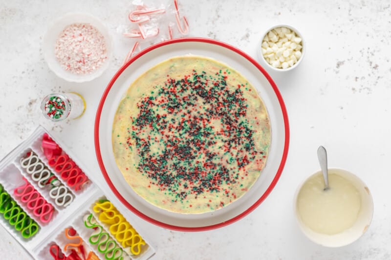 overhead view of christmas cheesecake on a red and white cake stand.