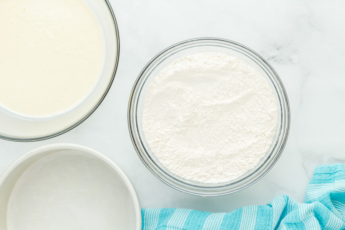 overhead view of dry ingredients for airplane cake in a glass bowl.