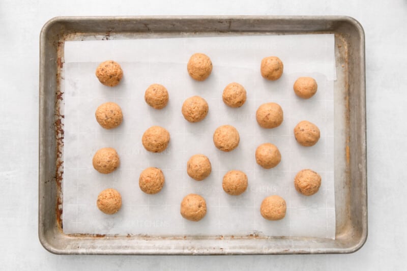 21 undipped butterfinger balls on a baking sheet.