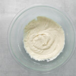 cream cheese frosting in a glass bowl.