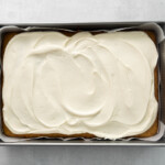 carrot cake with cream cheese frosting in a 9x13 cake pan.
