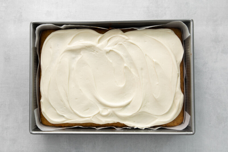 carrot cake with cream cheese frosting in a 9x13 cake pan.