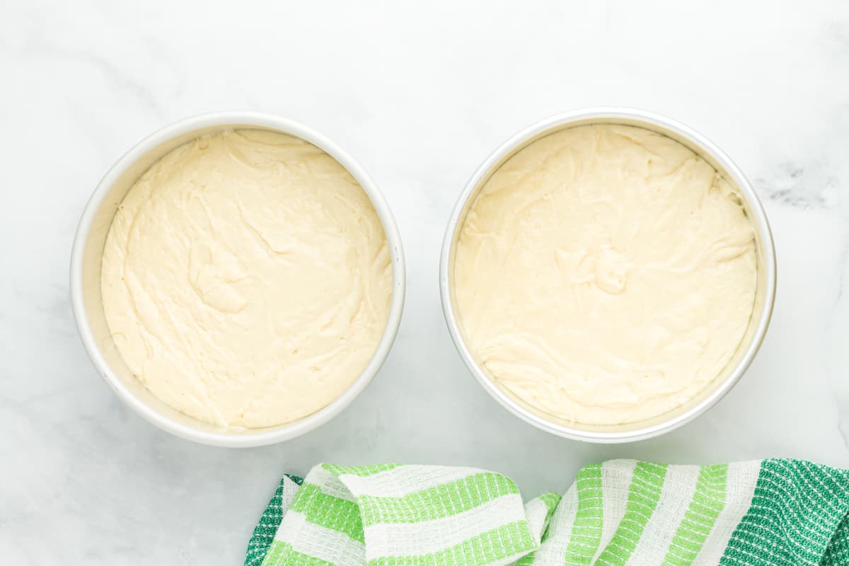 cake batter split between two round cake pans