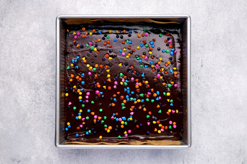 frosted brownies with rainbow sprinkles in a pan