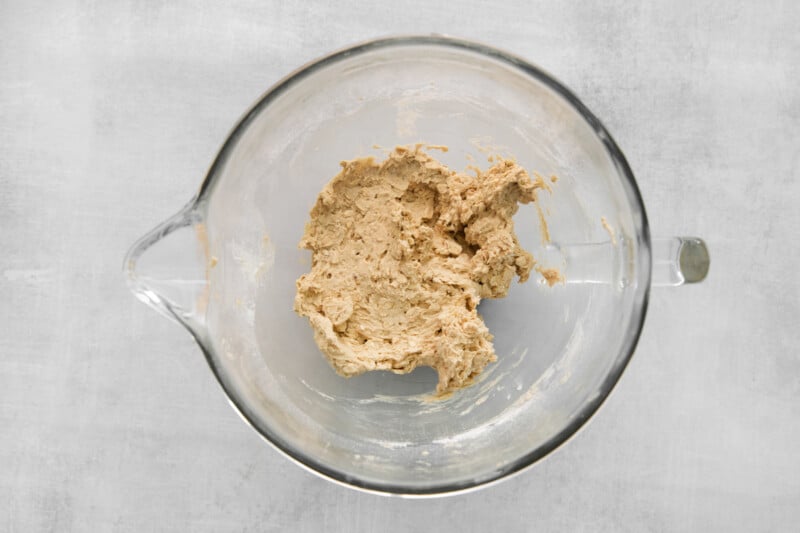 peanut butter in a glass bowl on a grey background.