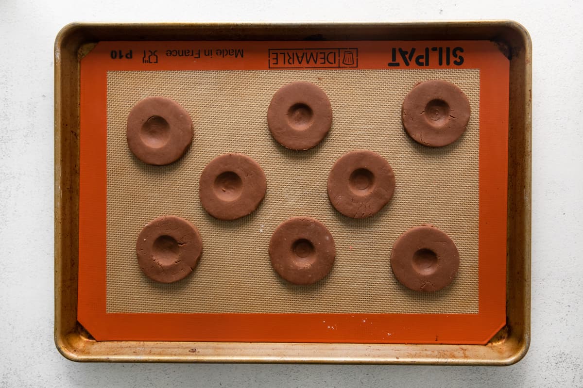 thumbprint cookies on a tray, before baking