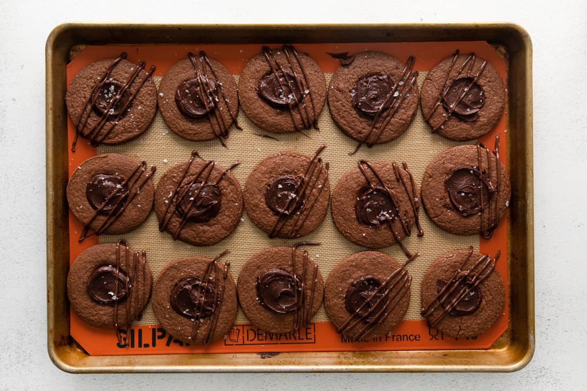 finished chocolate thumbprint cookies on a baking tray