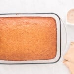 baked eggnog poke cake in a glass baking dish.