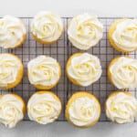 lemon curd cupcakes lined up on a cooling rack