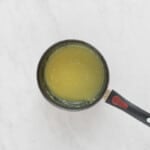 a frying pan with a yellow liquid in it.