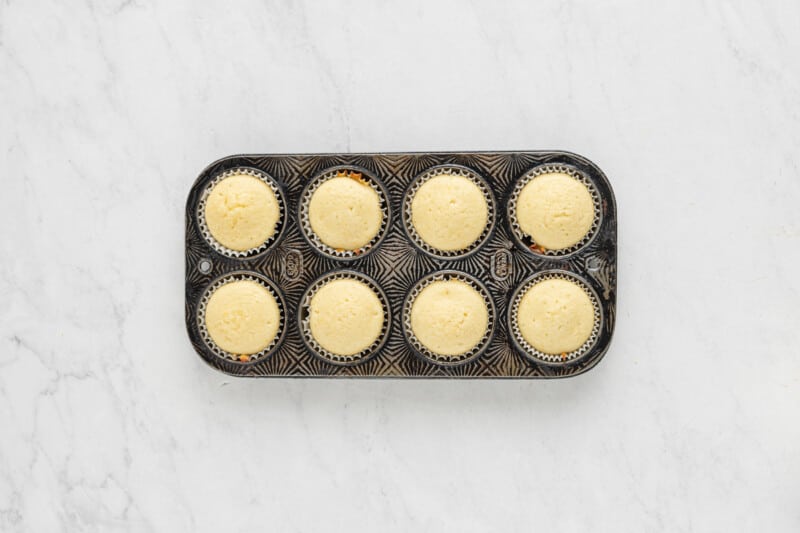 a muffin tin with six cupcakes in it.