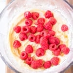 mixing raspberries into muffin batter