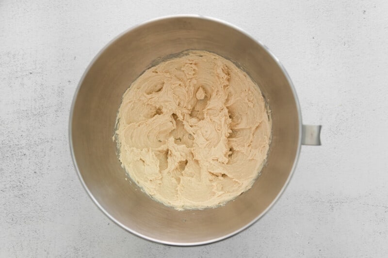 creamed butter, sugar, and maple syrup in a stainless mixing bowl.