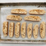 sliced maple pecan biscotti on a baking sheet.